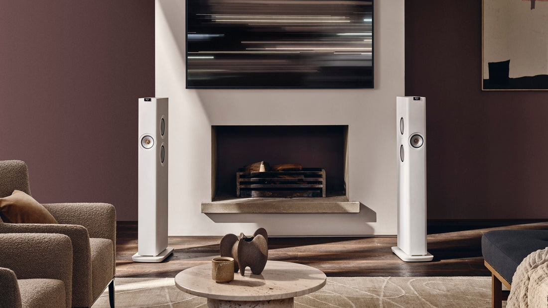 White KEF LS60 Wireless Speaker placed in modern living with a fireplace 