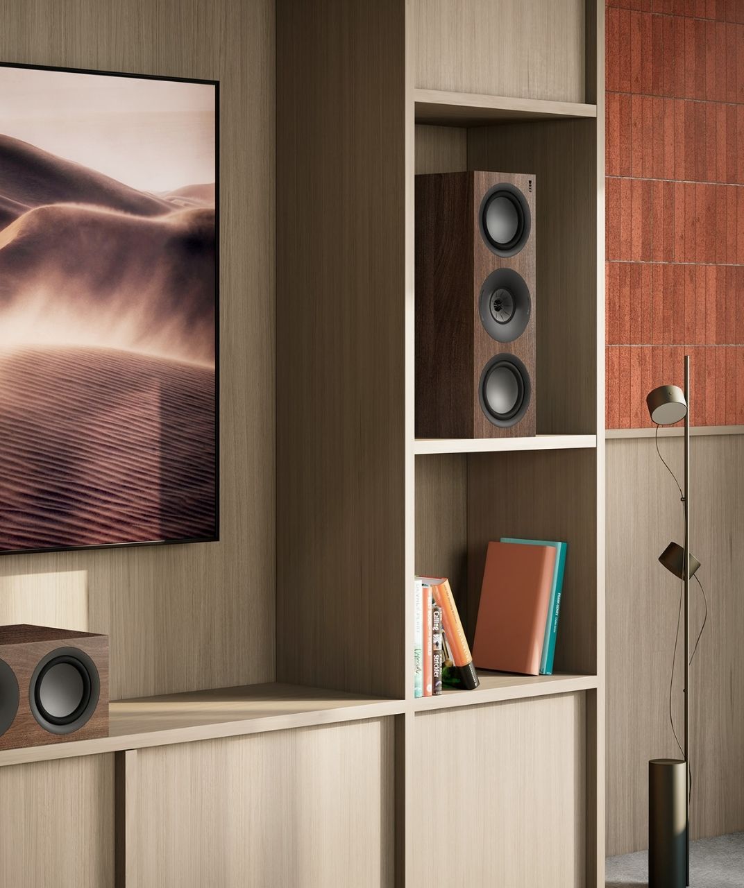 Walnut Q Series speakersin bookshelf next to TV.